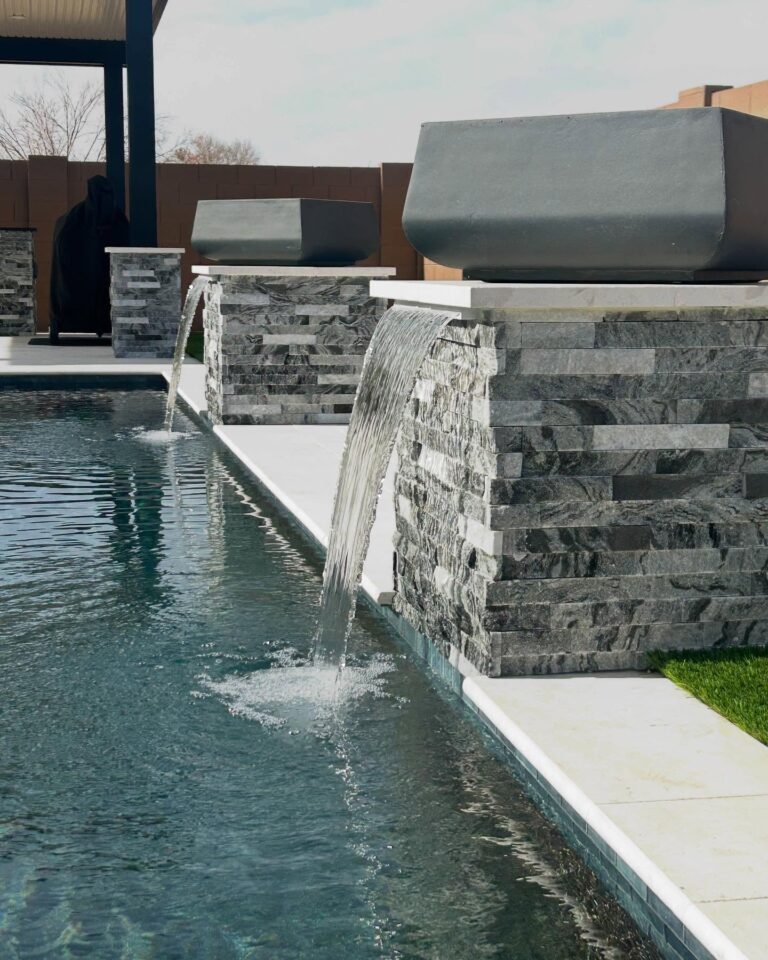 Swimming pool with waterfall feature.