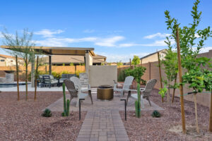 firepit seating area in backyard with custom lighting.