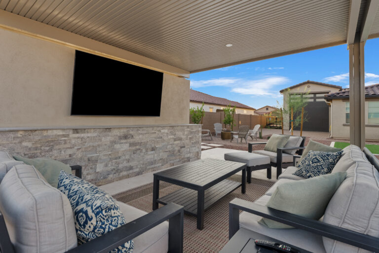 backyard pergola with entertainment wall built by Patriot Pools & Landscapes.