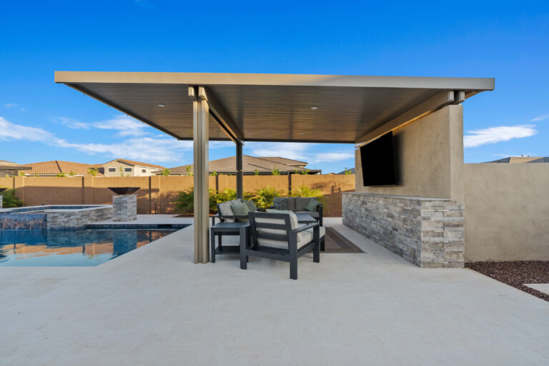 backyard pergola with entertainment wall built by Patriot Pools & Landscapes.