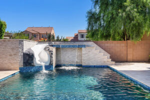 backyard pool with slide, fountain and grotto in queen creek.