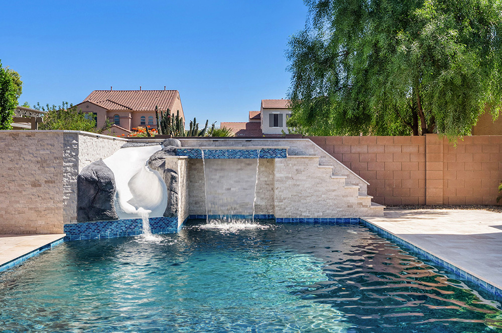 backyard pool with slide, fountain and grotto in queen creek.