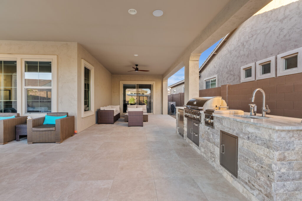 outdoor kitchen with bbq, fridge, sink and stovetop in queen creek az.