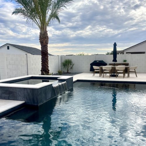 queen creek pool with spa and waterfall plus backyard landscaping with turf and travertine pavers.